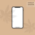 Mockup smartphone with white blank screen on beige background. Shadow overlay effect. Shadow from leaves of aralia Royalty Free Stock Photo