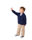 Mockup, space and child pointing up in studio isolated on a white background. Serious kid, hand gesture and advertising