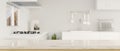 Mockup space on luxury granite kitchen tabletop over blurred white elegance kitchen interior