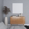 Mockup of square frame on a grey wall and sideboard with table decorations and ornamental plant Royalty Free Stock Photo