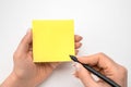 Mockup sticky Note Paper. Hand written notes black pencil on yellow sticker. white table background. Mockup sticky Note Paper. Royalty Free Stock Photo