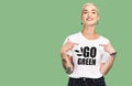 Mockup, sustainable fashion and green background, woman with tshirt and space for eco friendly product placement Royalty Free Stock Photo