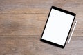 Mockup image of black tablet computer pc with blank white screen with pencil isolated on wood table. Royalty Free Stock Photo