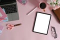 Mockup tablet with blank screen and laptop computer by various feminine equipment on female workspace. Royalty Free Stock Photo