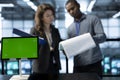 Mockup tablet in front of inspector next to server room admin checking documents