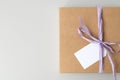 Mockup of a tag on a brown craft box with a ribbon. Space for text, copy space Royalty Free Stock Photo