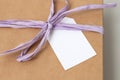 Mockup of a tag on a brown craft box with a ribbon. Space for text, copy space Royalty Free Stock Photo