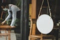 Mockup template blank vintage wooden sign board hanging on glass door in modern cafe restaurant, copy space for text advertising, Royalty Free Stock Photo