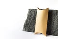 Mockup template with craft paper guft box standing next to raw natural black stone on white background