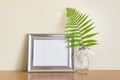 Mockup template with horizontal silver metallic wide frame and glass vase