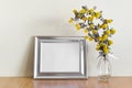 Mockup template with metallic horizontal wide frame canvas for art design photo presentation and yellow flowers