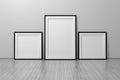 Mockup template with three frames square and A4 format standing on the floor Royalty Free Stock Photo