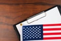 Mockup for text on clipboard with american flag, white sheet of paper in a folder for notes Royalty Free Stock Photo