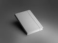Mockup of a textured white closed notebook with an elastic band, diary with a hard cover, isolated on a background with dark Royalty Free Stock Photo
