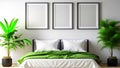 Mockup with a three-frame on a blank white wall in a bedroom with a bed, a green blanket, and a tropical plants Royalty Free Stock Photo