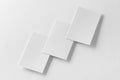 Mockup of three vertical business cards at white textured background.