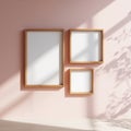 Mockup Three wooden frames of different sizes on a pale pink background Royalty Free Stock Photo