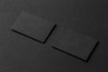 Mockup of two blank business cards at black textured background. Royalty Free Stock Photo