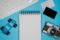 Mockup of two blank credit cards, paper note book, computer keyboard and retro camera on empty color desk. Business Royalty Free Stock Photo