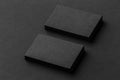 Mockup of two horizontal business cards at black textured background.