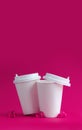 Mockup of two white coffee cups on a pink background with glass hearts. Layout for design. Vertical format. Copyspace Royalty Free Stock Photo