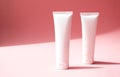 Mockup two white plastic tubes for cosmetic products. Container for hand cream, moisturizer body lotion, facial cleanser Royalty Free Stock Photo