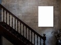 Mockup vertical artist frame, photo or white blank poster on concrete wall background over the empty vintage wooden stairs. Royalty Free Stock Photo