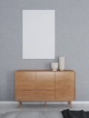 Mockup of vertical frame on a grey wall and sideboard with table decorations Royalty Free Stock Photo