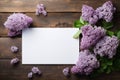 mockup white blank paper sheet with branch lilac flowers top view on wooden background, floral template empty card flat lay for