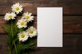 mockup white blank paper sheet with white daisies flowers top view on brown wooden background, floral template empty card flat lay Royalty Free Stock Photo