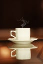 Mockup white cup with hot drink and steam on a mirror table with copy space. Hot steaming mug of coffee or tea with a Royalty Free Stock Photo