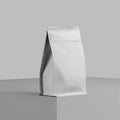 Mockup of a white doy pack for coffee beans, a presentation of zip packaging on a cube, close-up, isolated on a background Royalty Free Stock Photo