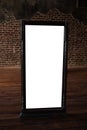 Mockup white framed mirror in a room with brick walls and brown floors Royalty Free Stock Photo