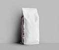 Mockup of white gusset packaging, transparent pouch with coffee beans on the side, isolated on wall background Royalty Free Stock Photo