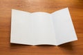 Mockup of white opened three fold brochure business on wooden Royalty Free Stock Photo