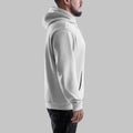 Mockup of white oversized hoodie on bearded man in dark jeans, side, textile apparel with pocket, laces, label for design, Royalty Free Stock Photo