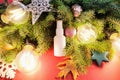 Mockup of white plastic spray bottle, Christmas fir tree and Christmas decorations on red background. Top view, flatlay style Royalty Free Stock Photo