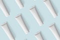 Mockup white plastic tubes pattern for cosmetic product. Containers for hand cream, moisturizer body lotion, facial cleanser Royalty Free Stock Photo