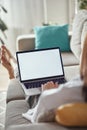 Mockup white screen laptop woman using computer lying on sofa at home, back view, focus on screen Royalty Free Stock Photo