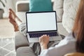 Mockup white screen laptop woman using computer lying on sofa at home, back view, focus on screen Royalty Free Stock Photo