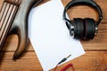 Mockup with a white sheet of paper with a guitar and headphones for music themes and drawings