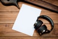 Mockup with a white sheet of paper with a guitar and headphones for music themes and drawings