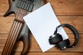 Mockup with a white sheet of paper with a guitar and headphones for music themes and drawings