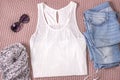 Mockup of white tank shirt with blue jeans, glasses and scarf. Summer outfit, flat lay