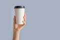 Mockup of woman hand holding a Coffee paper cup