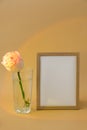 Mockup Wooden frame with Empty white paper blank and delicate pink roses on beige background. Minimal trendy composition