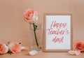 Mockup Wooden frame with text HAPPY TEACHERS DAY on blank and delicate pink roses on beige background. Minimal trendy