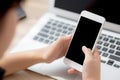 Mockup young businesswoman using smart mobile phone and laptop computer with screen blank on desk Royalty Free Stock Photo