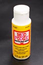 Mod Podge container matte glue isolated on black background