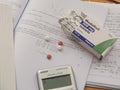 Modafinil cognitive enhancement drug and vitamins on a math book